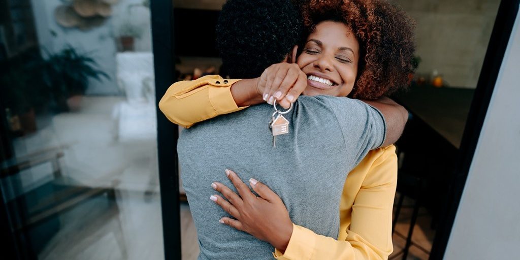 couple hugs as they understand and receive a bridge loan